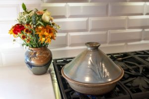 Clay Coyote Tagine in Mediterranean Blue on a stovetop